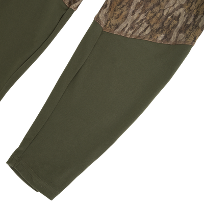 Drake Base Layer Bottom moisture-wicking olive green leggings with a camouflage pattern on the upper thigh panels.