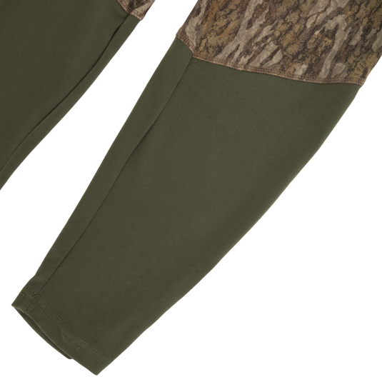 Drake Base Layer Bottom moisture-wicking olive green leggings with a camouflage pattern on the upper thigh panels.