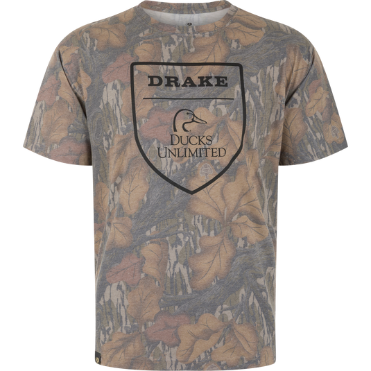 Drake X Ducks Unlimited Faded T-Shirt in a brown and tan Mossy Oak Fall Foliage camouflage print with a central shield logo featuring a duck head icon and the text Drake Ducks Unlimited.