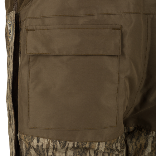 LST Guardian Elite Bibs: A close-up of a khaki military uniform pocket on the Drake Waterfowl bib. Made with waterproof Refuge HS Fabric and reinforced knees.