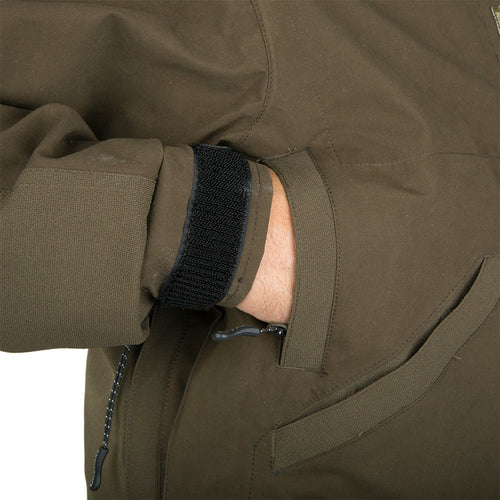 Guardian Elite Timber/Field Jacket: A person's hand in the jacket pocket, close-up of a black strap.