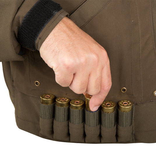 Guardian Elite Timber/Field Jacket: a hand holding a bullet in a vest