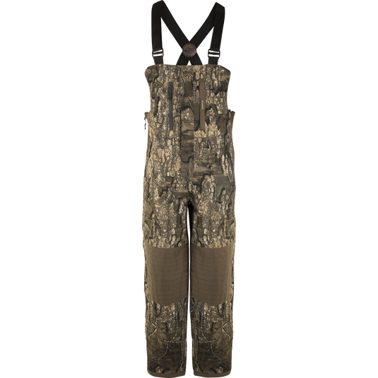 A product image of the EST Guardian Elite™ Bib Shell Weight, a camouflage overall with straps, made of 100% waterproof/windproof/breathable fabric.