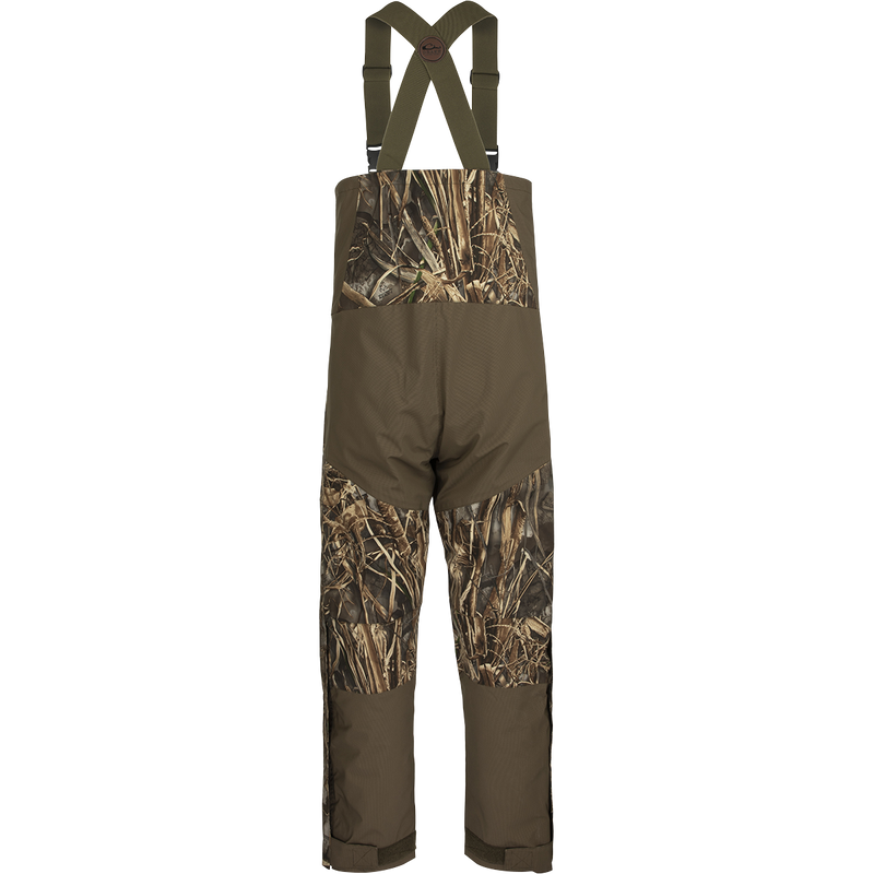 A person wearing Guardian Flex™ G3 Flex™ Bib with BMZ System Liner, adjustable suspenders, and camouflage shorts.