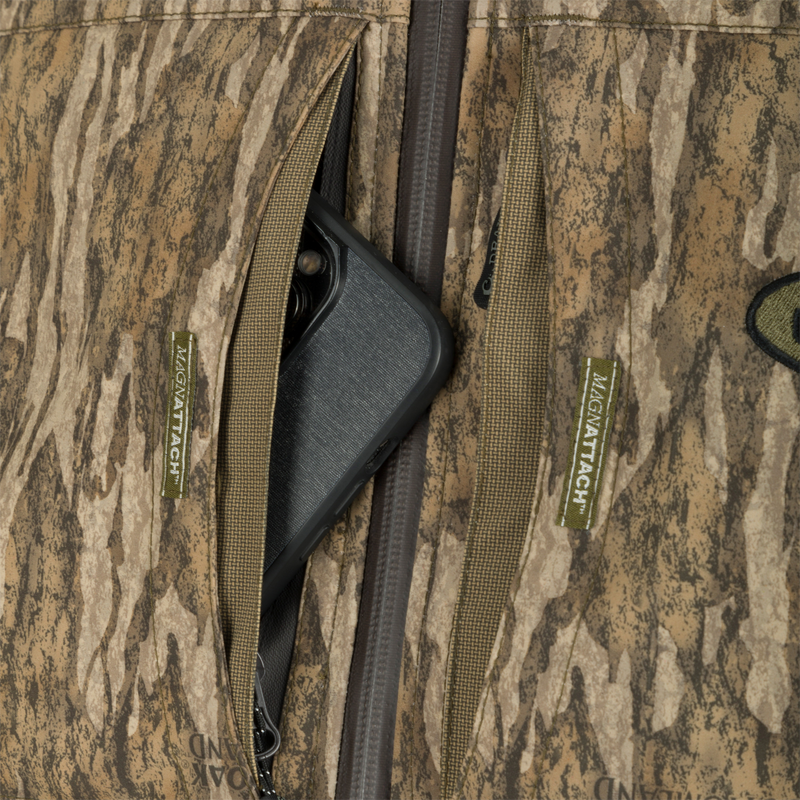 G3 Flex 3-in-1 Waterfowler's Jacket: A cell phone in a pocket, showcasing the jacket's versatility and functionality.