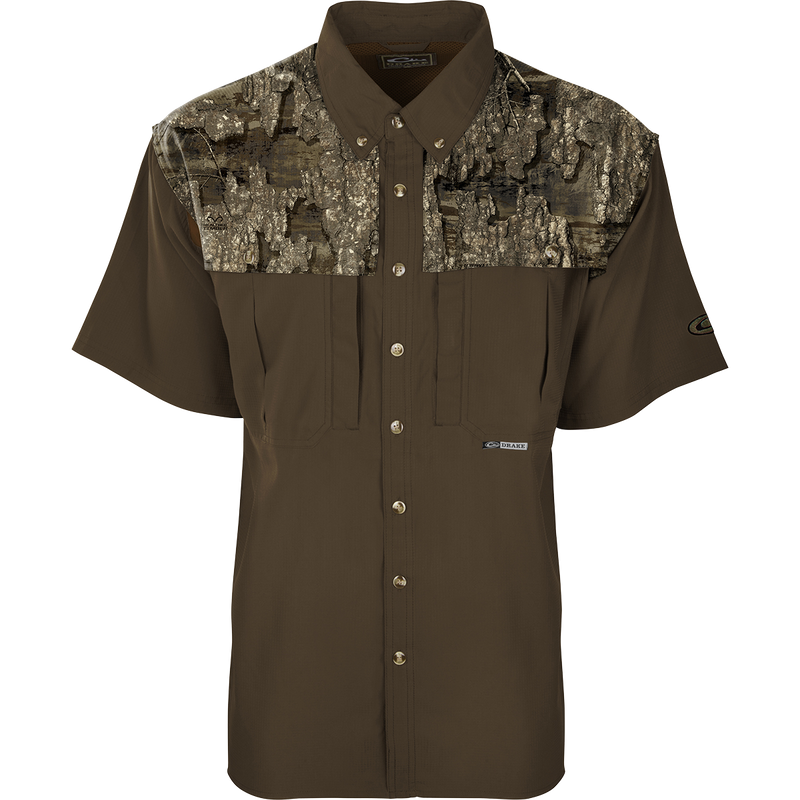 A brown shirt with a tree pattern, perfect for early season hunting. Made of ultra-lightweight polyester with UPF 50+ sun protection. Features include back heat vents, mesh side panels, and multiple chest pockets.