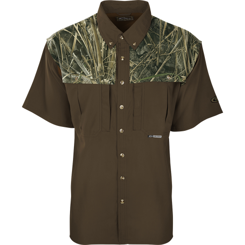 A brown camo shirt with buttons, featuring a close-up of the shirt's sleeve and collar. Perfect for early season hunting, it is made of ultra-lightweight polyester fabric with UPF 50+ sun protection. The shirt has back heat vents, mesh side panels, and two vertical chest pockets.