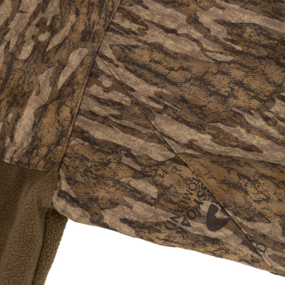 MST Quarter Zip Refuge Eqwader Jacket featuring camouflage fabric, highlighting waterproof and breathable materials with advanced features for waterfowl hunting comfort and performance.