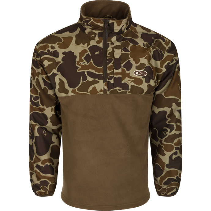 A camouflage MST 1/4 Zip Refuge Eqwader Pullover by Drake Waterfowl, featuring innovative waterproof/windproof/breathable fabric for hunters. Celebrating the Eqwader™ Hybrid System's legacy with advanced features for ultimate comfort and performance.
