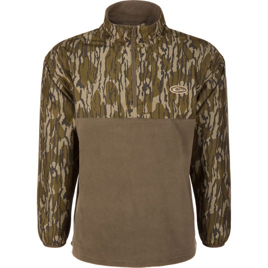 Waterfowl MST Quarter Zip Refuge Eqwader Jacket featuring a camouflage pattern on the upper chest, sleeves, and collar, with a solid olive lower section, designed to integrate with the Eqwader Hybrid System.