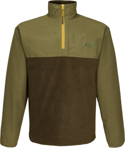 Close-up of the MST Quarter Zip Refuge Eqwader Jacket's zipper and logo, highlighting its innovative waterproof and breathable fabric design for enhanced hunting comfort.