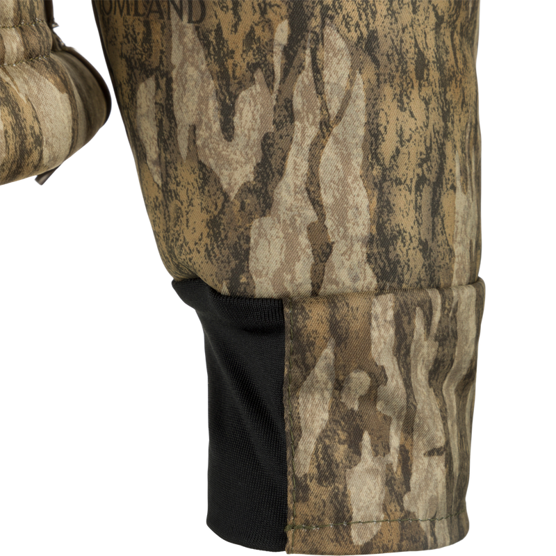 A close-up of the MST Hole Shot Windproof Eqwader 1/4 Zip Jacket, showcasing its camouflage fabric and Sherpa-lined, windproof upper body. Perfect for outdoor enthusiasts seeking superior protection and temperature control.