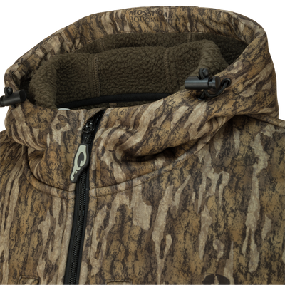 Close-up of the Ultimate Wader Quarter Zip Hoodie showcasing zipper, Sherpa-lined fabric, and Magnattach™ chest pocket, designed for warmth and functionality in mid-season hunting.