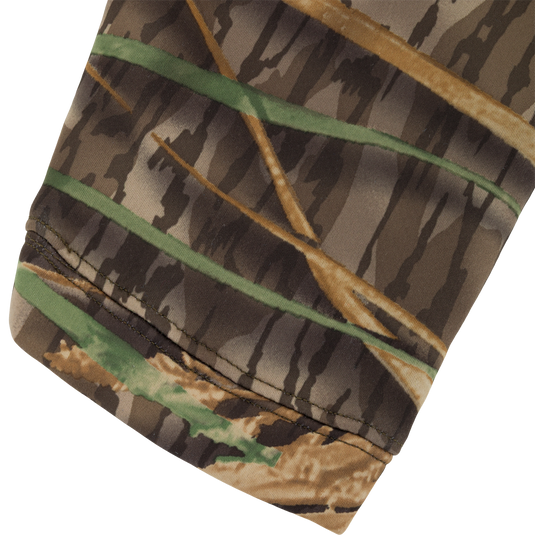 Close-up of a brown and green camouflage Slacker Wader Pocket Hoodie sleeve with a hemmed cuff.