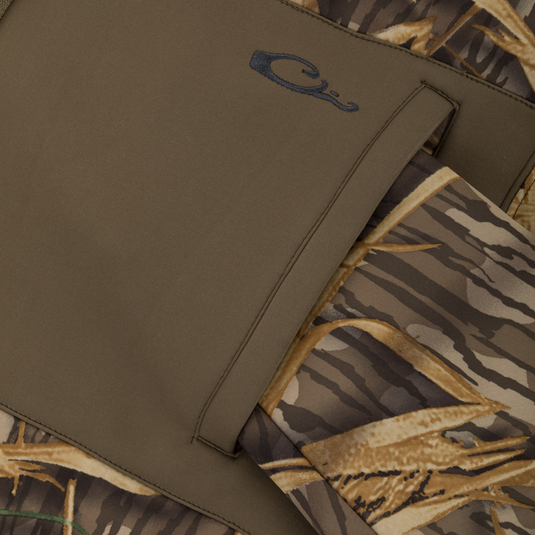 Close-up of a solid olive-green pocket on a camouflage patterned Slacker Wader Pocket Hoodie.