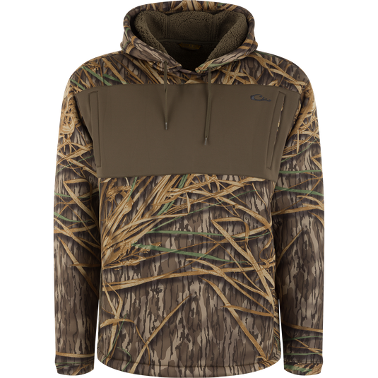 Slacker Wader Pocket Hoodie in Mossy Oak Original Shadow Grass camouflage with a solid olive green wader pocket and a fleece-lined hood.