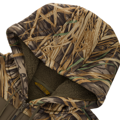 Waterfowl Slacker Quarter Zip Hoodie with High Handwarmer Pockets in a camouflage grass pattern featuring a fleece-lined hood.