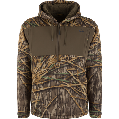 Slacker Quarter Zip Hoodie with High Handwarmer Pockets in Mossy Oak Original Shadow Grass camouflage with a solid brown chest panel and a fleece-lined hood.