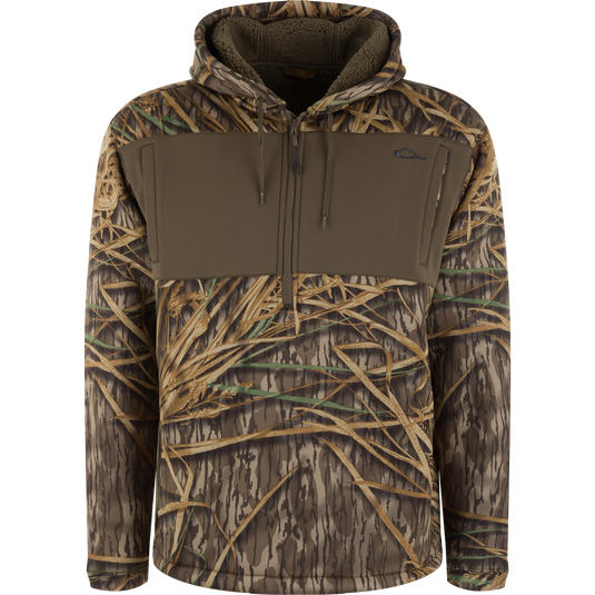 Slacker Quarter Zip Hoodie with High Handwarmer Pockets in Mossy Oak Original Shadow Grass camouflage with a solid brown chest panel and a fleece-lined hood.