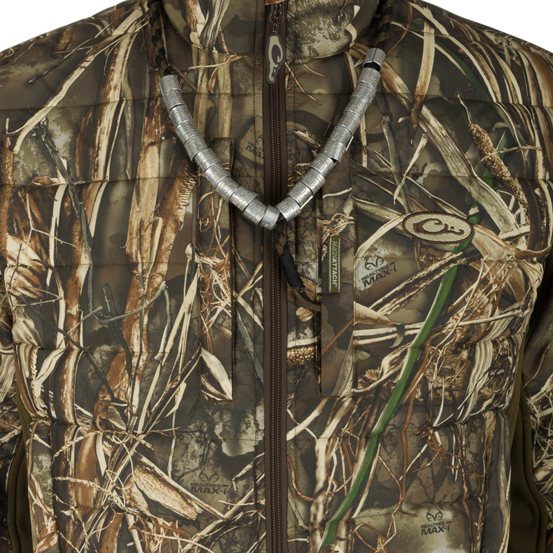 A close-up of the LST Double Down Endurance Hybrid Liner - Realtree jacket, showcasing its matte-finish face fabric, reverse coil zippers, and zippered lower slash pockets.