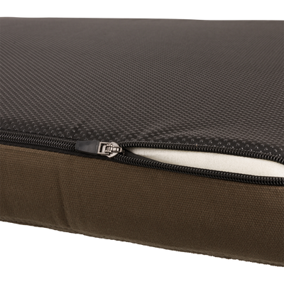 Team Gun Dog Landing Zone Quilted Canvas Dog Bed with non-slip textured black top, partially opened zipper, and visible white memory foam core.