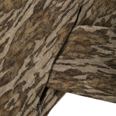 RTL - Half Zip Pullover with Spider Web Technology, featuring camo fabric, a zippered pocket, and ergonomic thumbholes, designed for turkey hunting with breathable, durable materials.
