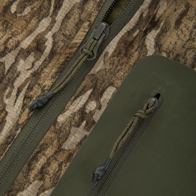 Close-up of the RTL - Half Zip Pullover's camouflage fabric, featuring an olive-green zipper with paracord pull, highlighting its durable, breathable Spider Web Technology.
