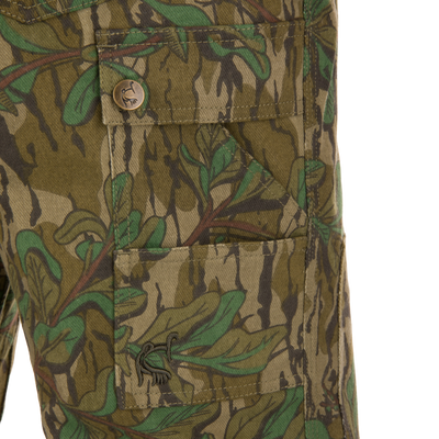 Close-up of the Throwback 80 Field Pant's antique brass riveted pocket and camouflage fabric detail, highlighting durable craftsmanship and functionality for hunting enthusiasts.