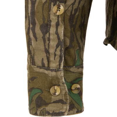 Close-up of the Throwback 80 Button Down Field Shirt, showcasing its camouflage fabric, durable triple-needle stitching, and reinforced buttons, ideal for outdoor adventures.