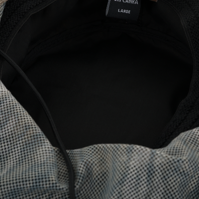 Close-up of the DUK Boonie Hat with Facemask's interior, showing black lining, draw-cord, and micro-check pattern; labeled LARGE for hunting enthusiasts.