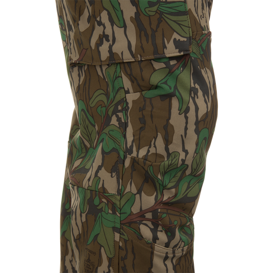 Close-up of Ol' Tom Tech Stretch Turkey Pants showcasing camouflage pattern, large cargo pockets, and articulated knee panels for enhanced flexibility and storage.