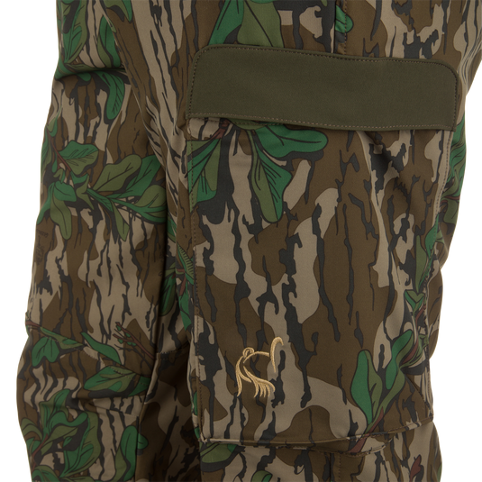 Ol' Tom Tech Stretch Turkey Pants in camouflage pattern, featuring a hidden stretch waistband, large cargo pockets, and articulated knee panels for enhanced comfort and functionality.