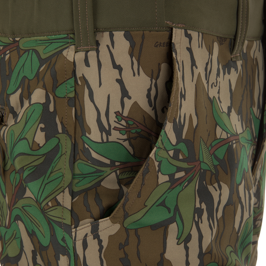 Close-up of Ol' Tom Tech Stretch Turkey Pants, showcasing camouflage pattern and durable, flexible fabric with functional cargo pockets and articulated knee panels for hunting.