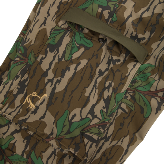Close-up of Ol' Tom Tech Stretch Turkey Pants showcasing camouflage pattern and cargo pockets designed for comfort and functionality in hunting apparel.