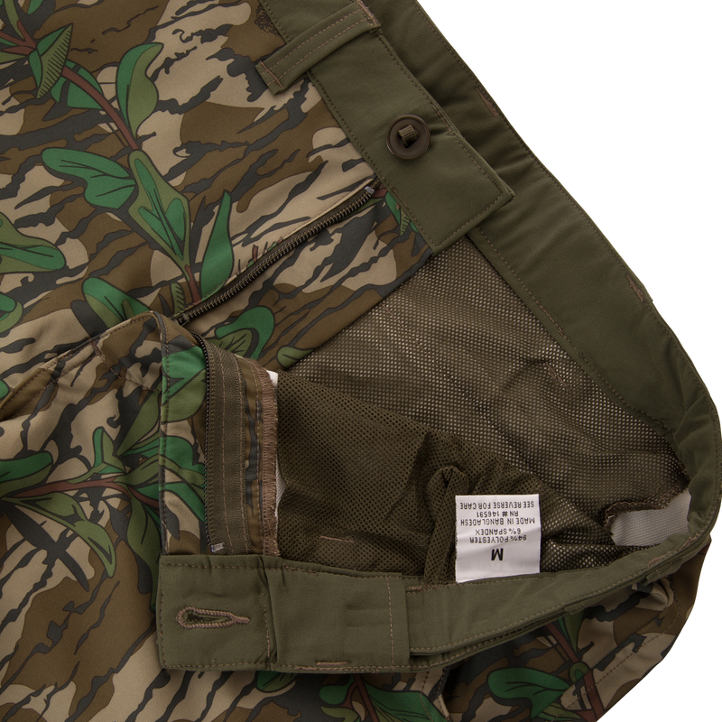 Close-up of Ol' Tom Tech Stretch Turkey Pants showing camouflage pattern, button, and zipper details, emphasizing functionality and comfort for hunting enthusiasts.