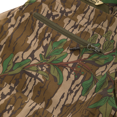 Turkey Bib with Spider Web Technology featuring a close-up of its durable zipper on camouflage fabric, highlighting water-resistant and breathable design for hunting comfort.