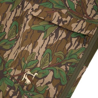 Close-up of a camouflage pocket on the Turkey Bib with Spider Web Technology, highlighting breathable, durable fabric with functional storage for hunting essentials.