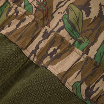 Close-up of the Turkey Bib featuring Spider Web Technology, highlighting the camouflage fabric's detail and durable, breathable polyester construction for optimal hunting performance.