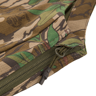 Close-up of the Turkey Bib with Spider Web Technology, showcasing a durable zippered side and camouflage fabric, ideal for hunting comfort and mobility.