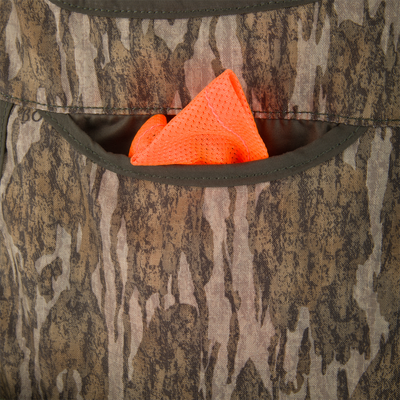 Turkey Strap Vest close-up showing camouflage fabric with olive pocket and high-visibility orange mesh cloth, designed for efficient turkey hunting gear organization and safety compliance.