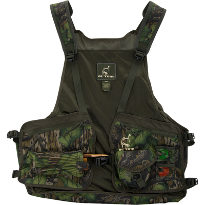 Ol’ Tom Turkey Strap Vest with camo pattern, featuring mesh back, multiple pockets for calls, adjustable straps, and removable padded seat for optimal hunting utility.
