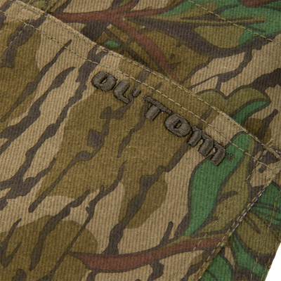 Throwback 80 Field Bib showcasing a close-up view of a durable fabric pocket with antique brass rivets, emphasizing heavy-duty craftsmanship and vintage style.