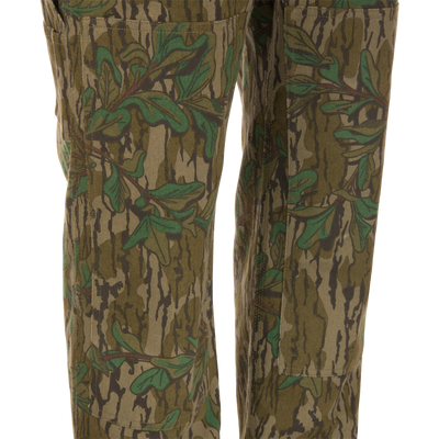 Throwback 80 Field Bib, camouflage pants made from heavy-duty cotton twill, featuring antique brass riveted pockets, triple stitching, and double-layer knee reinforcement.