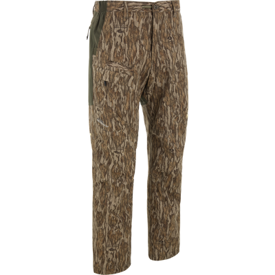 Ol' Tom Early Bird SWT Pant with Mossy Oak Bottomland camo, featuring multiple pockets, stretch mobility, and insect-repellent technology, ideal for warm-weather turkey hunting.