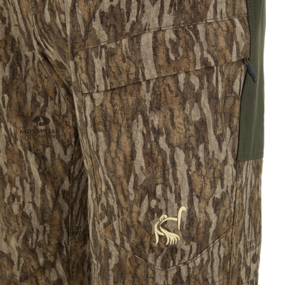 Ol' Tom Early Bird SWT Pant in Mossy Oak Bottomland camo, showcasing breathable stretch fabric, pocket details, and insect-repellent technology for warm-weather hunting.