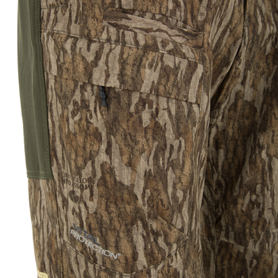 Close-up of Ol' Tom Early Bird SWT Pant showcasing the cargo pocket, toggle cord, and “Xtra Protection” embroidery, highlighting its lightweight, durable design for warm-weather hunts.