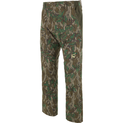 Ol' Tom Early Bird Spider Web Technology Pant with camo print, cargo pockets, elastic panels, and embroidered logo, designed for mobility and insect protection during hunting.