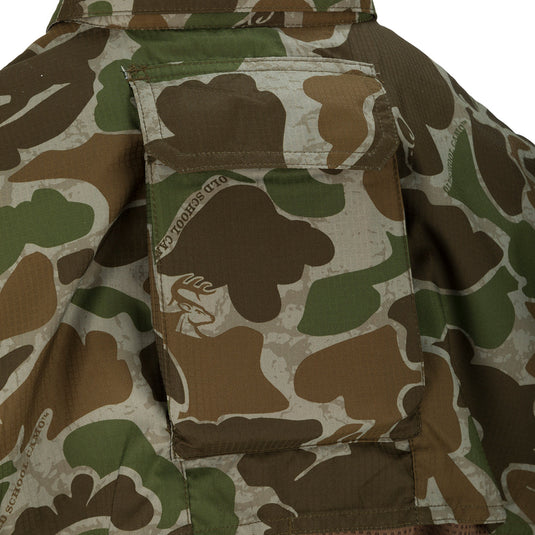 A close-up of the Women's Mesh Back Flyweight Shirt 2.0, a camouflage jacket with a logo patch and large chest pockets.
