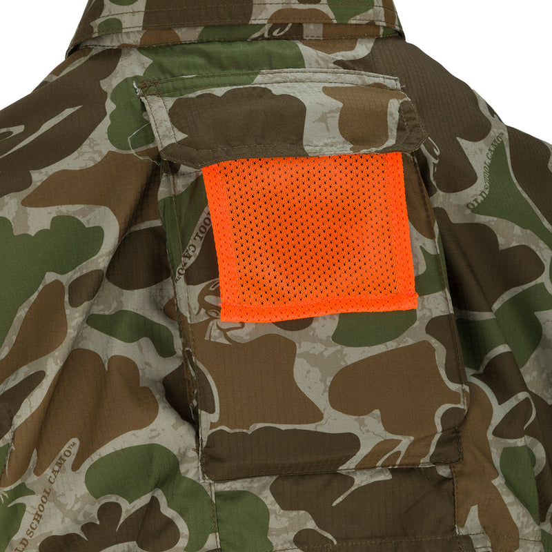 A close-up of the Women's Mesh Back Flyweight Shirt 2.0, a lightweight and breathable hunting shirt with a camouflage pattern and mesh back panel. Features include a button-down collar, UPF 50+ sun protection, and two large chest pockets. Perfect for outdoor adventures.