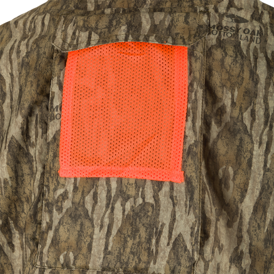 A close-up of the Ol’ Tom Men's Mesh Back Flyweight Turkey Shirt with a camouflage pattern and a patch.
